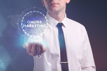 The concept of business, technology, the Internet and the network. A young entrepreneur working on a virtual screen of the future and sees the inscription: Online marketing