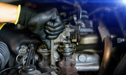 Auto mechanic Preparing For the work. Mechanic with Stainless Steel Wrench in Hand.Close up of hands mechanic doing car service and maintenance.Engine Maintenance concept