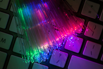 Colourful optic fibers illuminated on dark background. High speed internet concept. Data transfer...