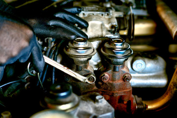 Auto mechanic Preparing For the work. Mechanic with Stainless Steel Wrench in Hand.Close up of hands mechanic doing car service and maintenance.Engine Maintenance concept