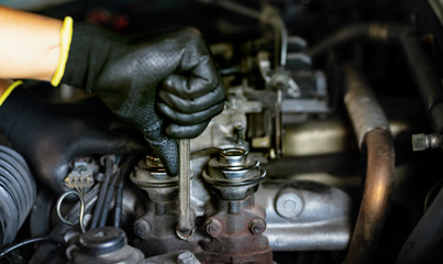 Auto mechanic Preparing For the work. Mechanic with Stainless Steel Wrench in Hand.Close up of hands mechanic doing car service and maintenance.Engine Maintenance concept