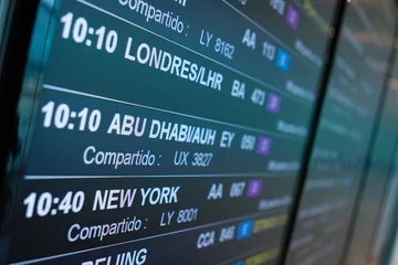 Papier Peint photo Abu Dhabi Airport board departures announces the next flights timetable