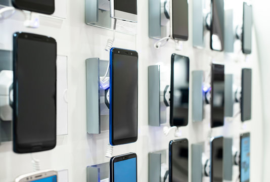 Smartphones on shelf in the store. Concept for communications and technology.
