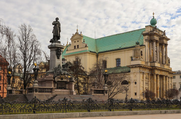 Fototapeta na wymiar Adam Mickiewicz monument and Church of Saint Joseph at the center of Warsaw, Poland
