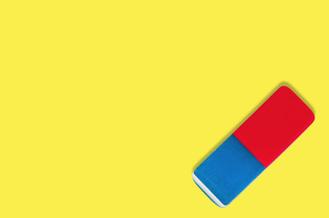 Single rectangular rubber eraser for pencil and pen ink on yellow background with copy space for your text