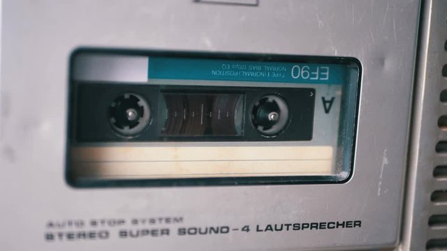 Audio Tape. Vintage Tape Recorder Plays Audio Cassette inserted therein