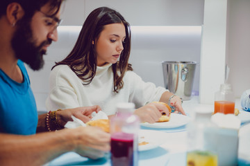 Serious couple having lunch with friends