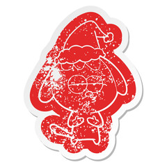 cartoon distressed sticker of a bored dog wearing santa hat