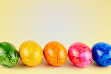 Colored Easter eggs on yellow background