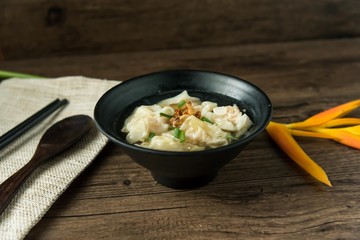Shrimp wonton with braised pork in soup on wooden table - Asian food style  / Select focus image