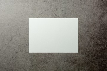 blank white paper on cement floor. - for message and advertising background.