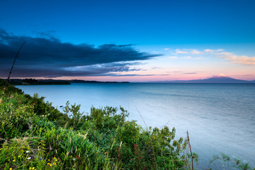 View of Llanquihue Lake and Osorno volcano in the Chilean Lake district at sunset.