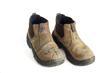 pair of old used construction boots isolated on white