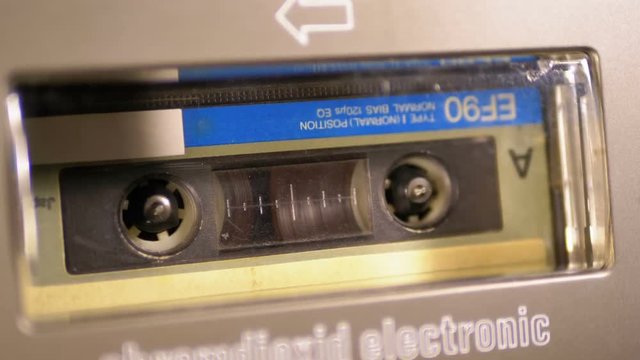 Audio Cassette in the Tape Recorder Playing and Rotates.