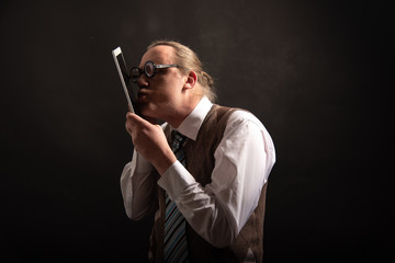 Funny nerd or geek looking on tablet with empty placeholder