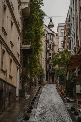 Fototapeta na wymiar Narrow streets of old town district in Istanbul, Turkey at rainy day