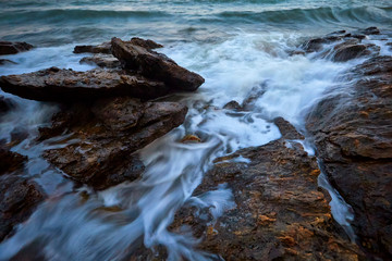The seascape of waves and rocks in Thailand with movement of shutter speed long exposure  