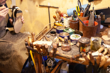 shoemaker performs shoes in the studio craft