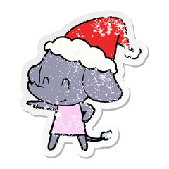 cute distressed sticker cartoon of a elephant wearing santa hat