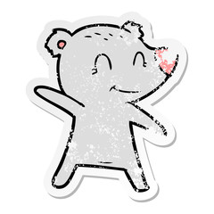 distressed sticker of a smiling bear pointing