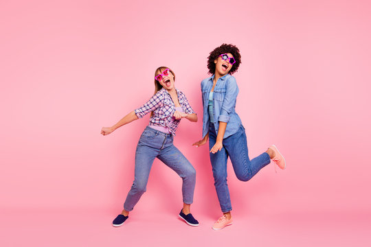 Full length body size portrait of two person nice-looking cool crazy careless carefree attractive charming playful girls wearing casual checkered shirt having fun isolated over pink pastel background