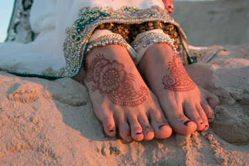 Feet painted with henna. Indian girl's legs. Mehendi