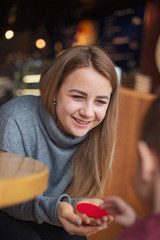 happy family, blonde mother and her beautiful and charismatic little son, the boy is having fun day in a cozy cafe. selective focus, noise effect
