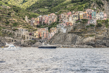 Fototapeta na wymiar Italy, Cinque Terre, Riomaggiore, Manarola, SAILBOATS IN SEA AGAINST BUILDINGS IN CITY