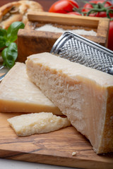 Original italian cheese, aged Parmesan cow milk cheese, pieces and grated Parmigiano-Reggiano