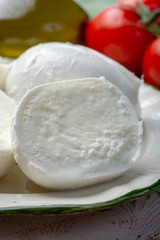 Balls and pieces of buffalo mozzarella, soft Italian scheese made from the milk of Italian Mediterranean buffalo
