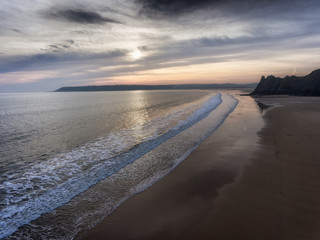 Dusk at Three Cliffs Bay showing the Great Tor and Oxwich Bay on the Gower peninsula in Swansea, South Wales, UK