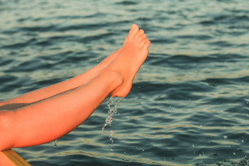 Woman's feet in a swimming pool under water jets
