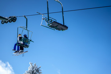Snowboarder and Skier on Chairlift