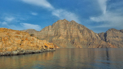 Beautiful mountains reflected in the water. Fjords on the Musandam peninsula. Khasab. Oman