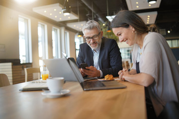 Sales business meeting between man and woman in modern office space