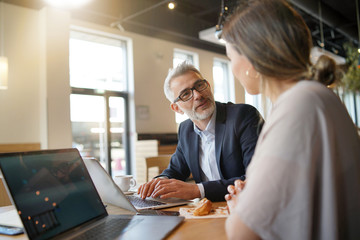 Sales meeting in modern open plan office space