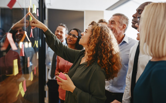 Diverse Businesspeople Brainstorming With Sticky Notes In An Off