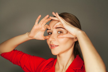 A woman shows face yoga exercises. Concept massage and face care for young skin.