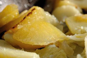 Freshly fried potatoes in a pan closeup. Shallow depth of field