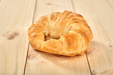 fresh baked croissant on wooden table