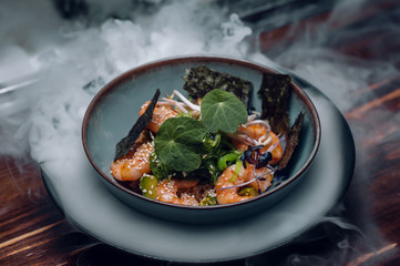 prawn salad with avocado, sea kale and sesame in ice vapor.