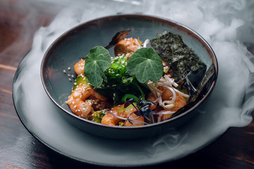 prawn salad with avocado, sea kale and sesame in ice vapor.