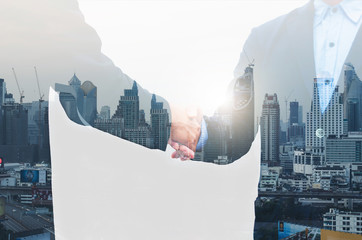 business man greeting with shaking hands partnership successful corporate dealing working together concept with double exposure of night cityscape in city metropolis landscape.