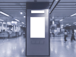 blank billboard white screen LED vertical advertising ad banner board indoor in subway station public hall.
