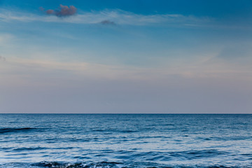 Fototapeta premium Seascape with clouds hanging over calm sea in calm weather.