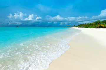 Fototapeta na wymiar Maldives island with white sandy beach and sea