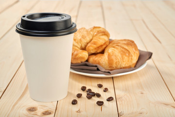 coffee with croissant on a wooden table