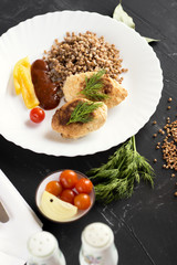 Chicken cutlets with buckwheat, herbs, ketchup and tomatoes