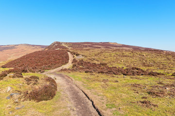 Narrow footpath winds up Derwent Moor in the Derbyshire Peak District.