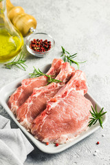 Raw steaks and spices, culinary background. Selective focus, space for text.